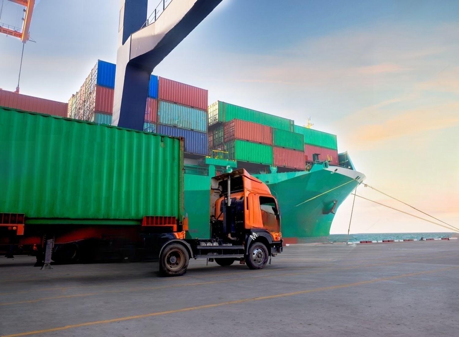 stock-photo-the-container-discharging-from-the-vessel-at-the-port-and-move-to-container-yard-by-truck-2298123091-transformed
